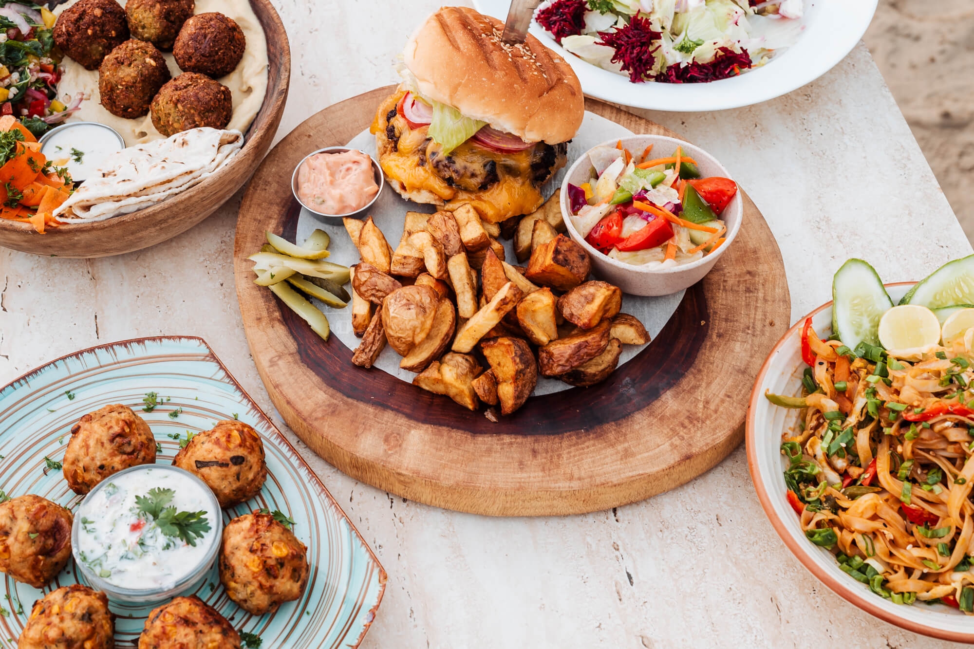 Open-air garden dining at Nada Brahma under the palm trees